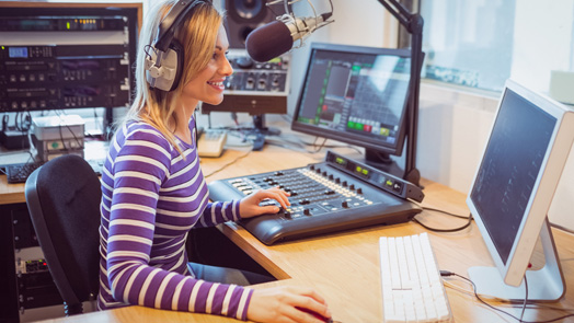 Female radio host broadcasting through microphone