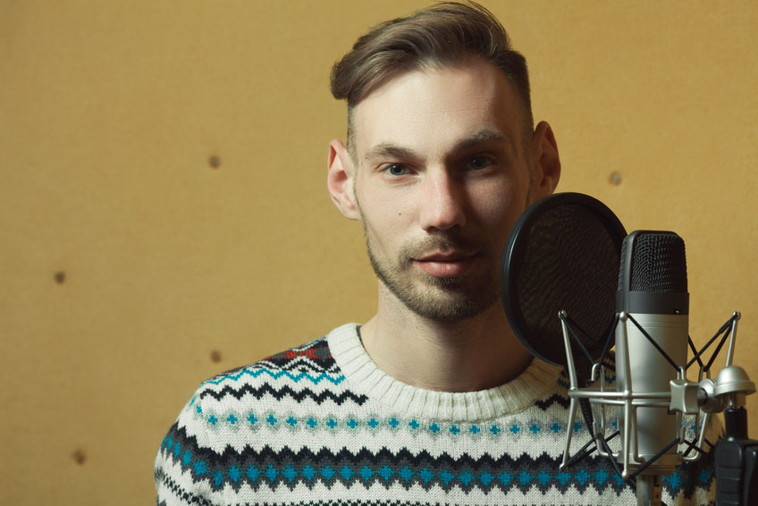 Radio dj concept. Portrait of handsome young man with blond hair